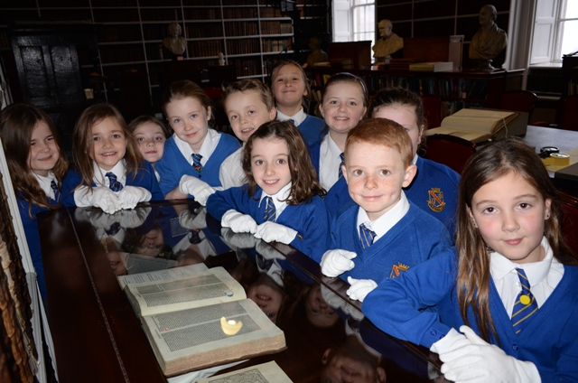 School visit to the Library: Primary school children at one of the display cabinets in the Long Room