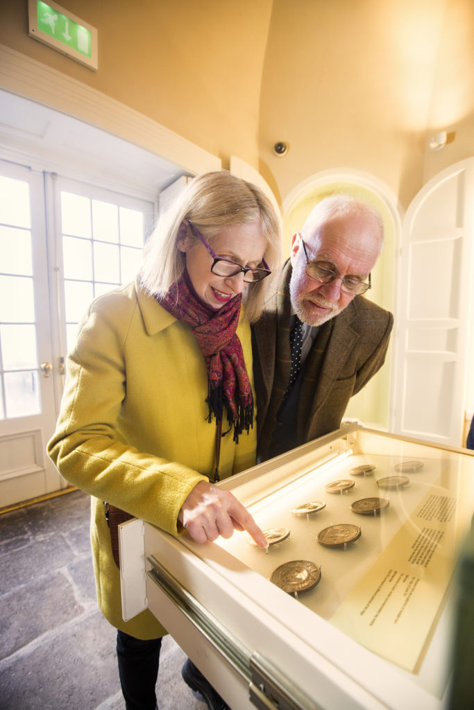 Visitors looking at the medals and coins at No 5 Vicars' Hill