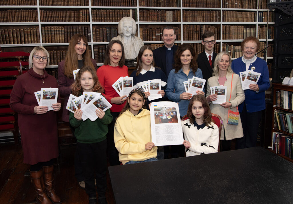 Staff of the Library and members of Ukrainian families in COunty Armagh holding Ukrainian Translation Library Flyers.